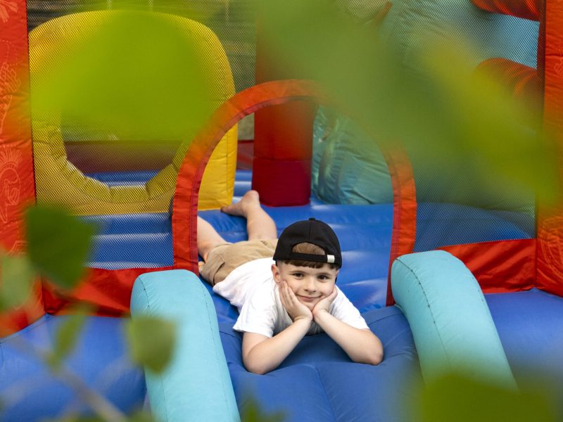 full-shot-smiley-boy-bounce-house